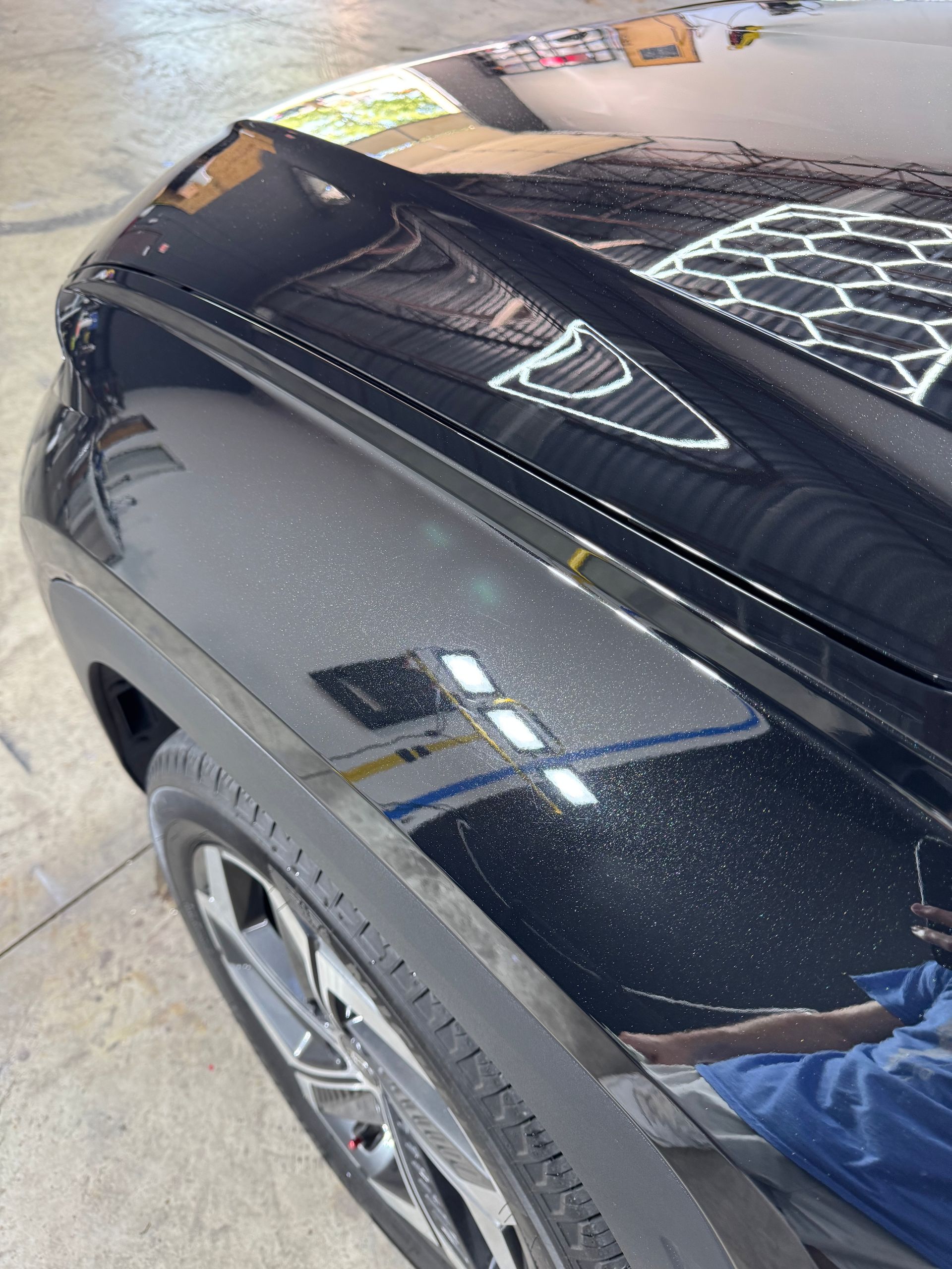 Close-up of vehicle paint under detailing lights